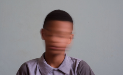 a boy with a blurred face