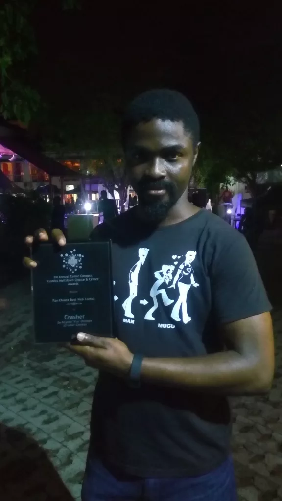 Kayode Onimole holding his award, 2016